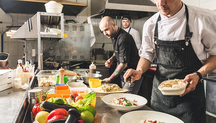 Chefs working in kitchen galley and preparing food