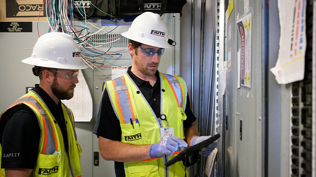 Factory worker showing the contractor the systems