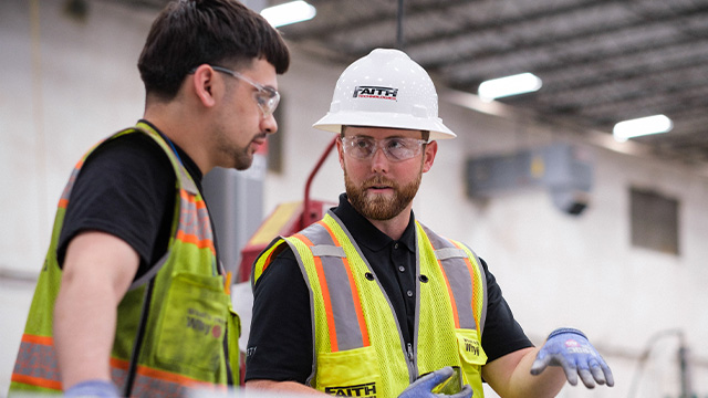 Factory worker talking to contractor