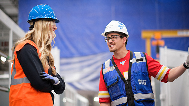 One factory worker talking to a contractor