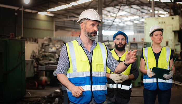 Worker instructing employees