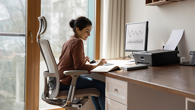Women office worker using proper ergonomics at her home office