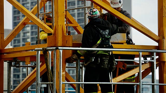 Workers standing on scaffolding