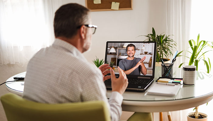 Worker communicating on video call in sign language