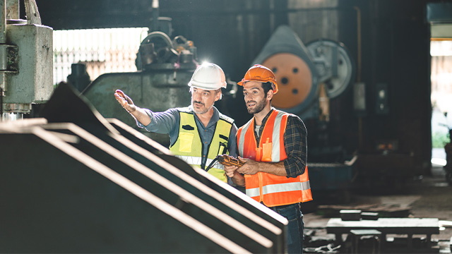 professional technician engineer with safety helmet hard hat working in industrial manufacturing factory, men at work to checking equipment of machinery production technology or construction operating