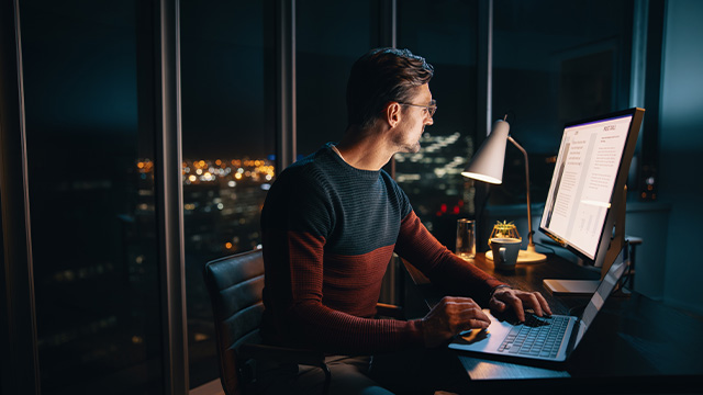 male office worker working from home in the middle of the night
