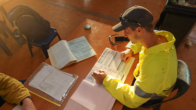 Worker writing down management plan