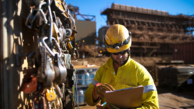 Construction worker reading checklist