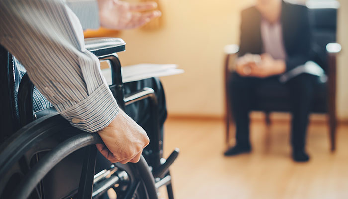 Person in a wheelchair participating in a meeting