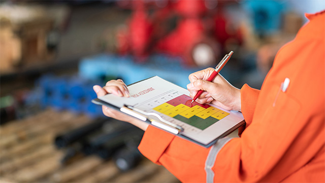 Construction worker using a risk matrix to assessment the job site before beginning