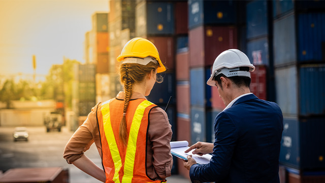 Female construction worker talking to the male site manager discussing the safety operating procedure