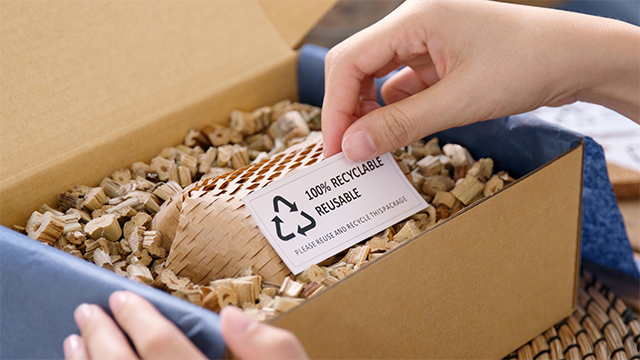 Worker using environmentally friendly packaging for their business