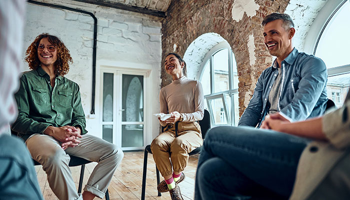 Team participating in a round circle discussion