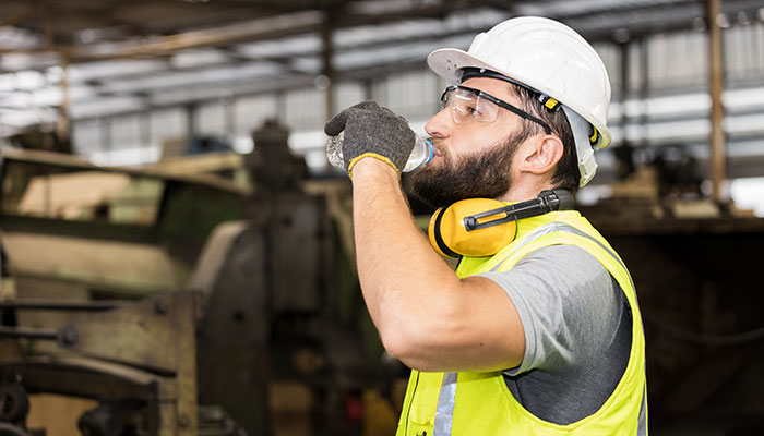 Tradesperson staying hydrated drinking water