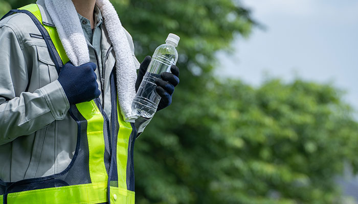 Worker with water and cool towel